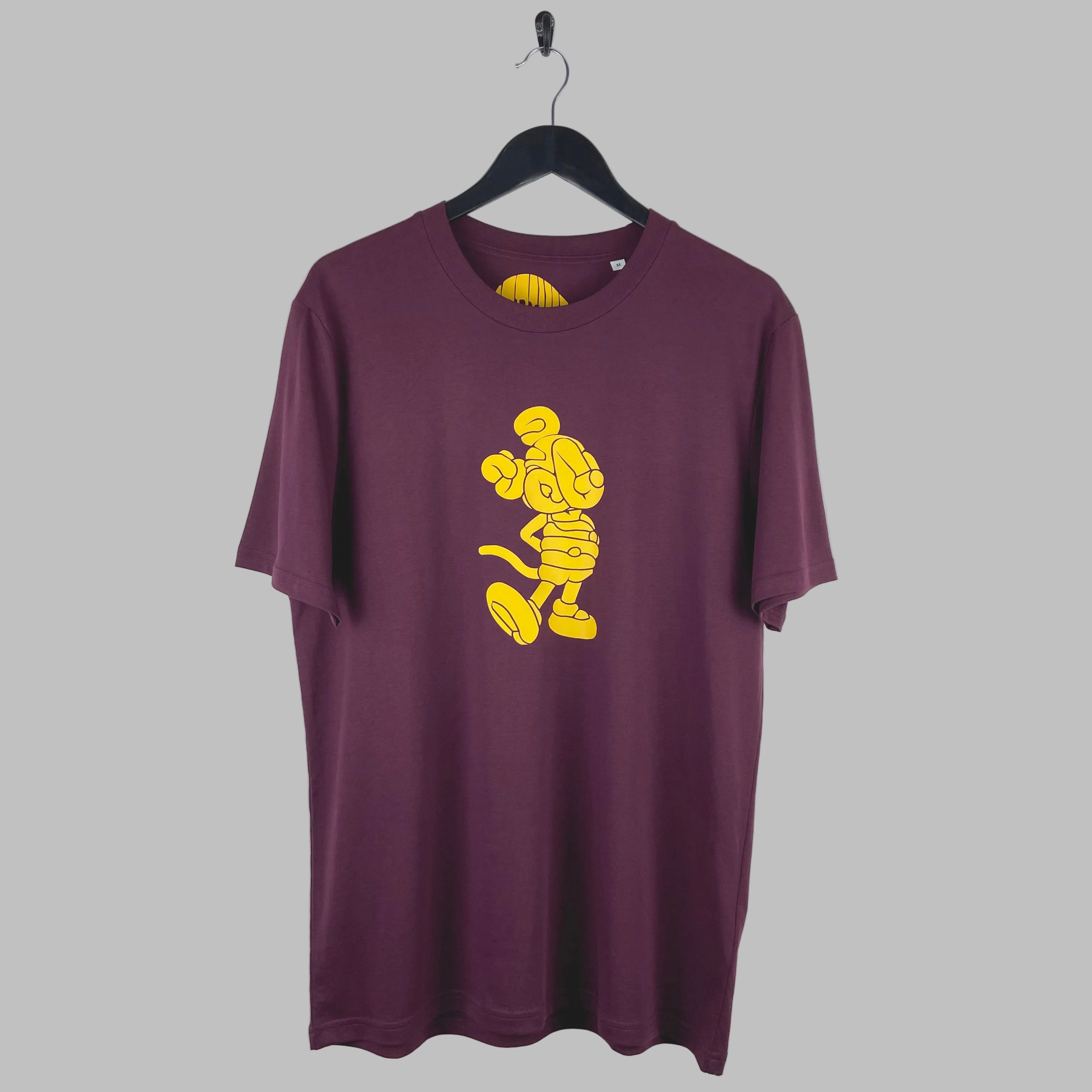 Yellow peeky free design on a plum t-shirt. Limited edition and hand printed in Brighton.